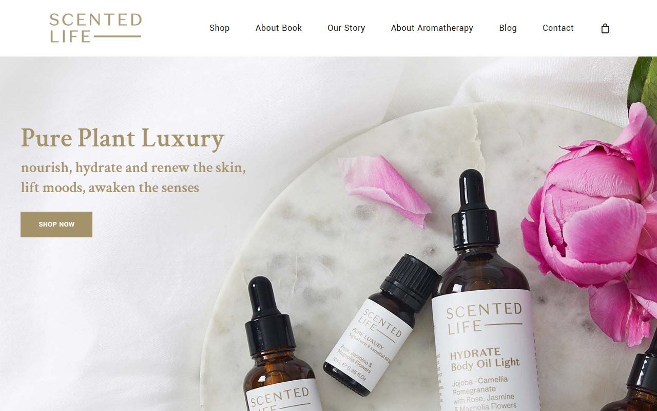 Scented Life online store homepage, with skincare oil bottles and a pink peony
